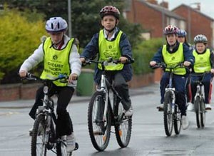 Children learning to ride their bikes safely on the road